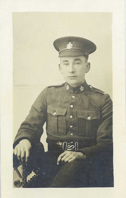 Portrait en noir et blanc – Archie pose assis, en uniforme, durant la Première Guerre mondiale.
